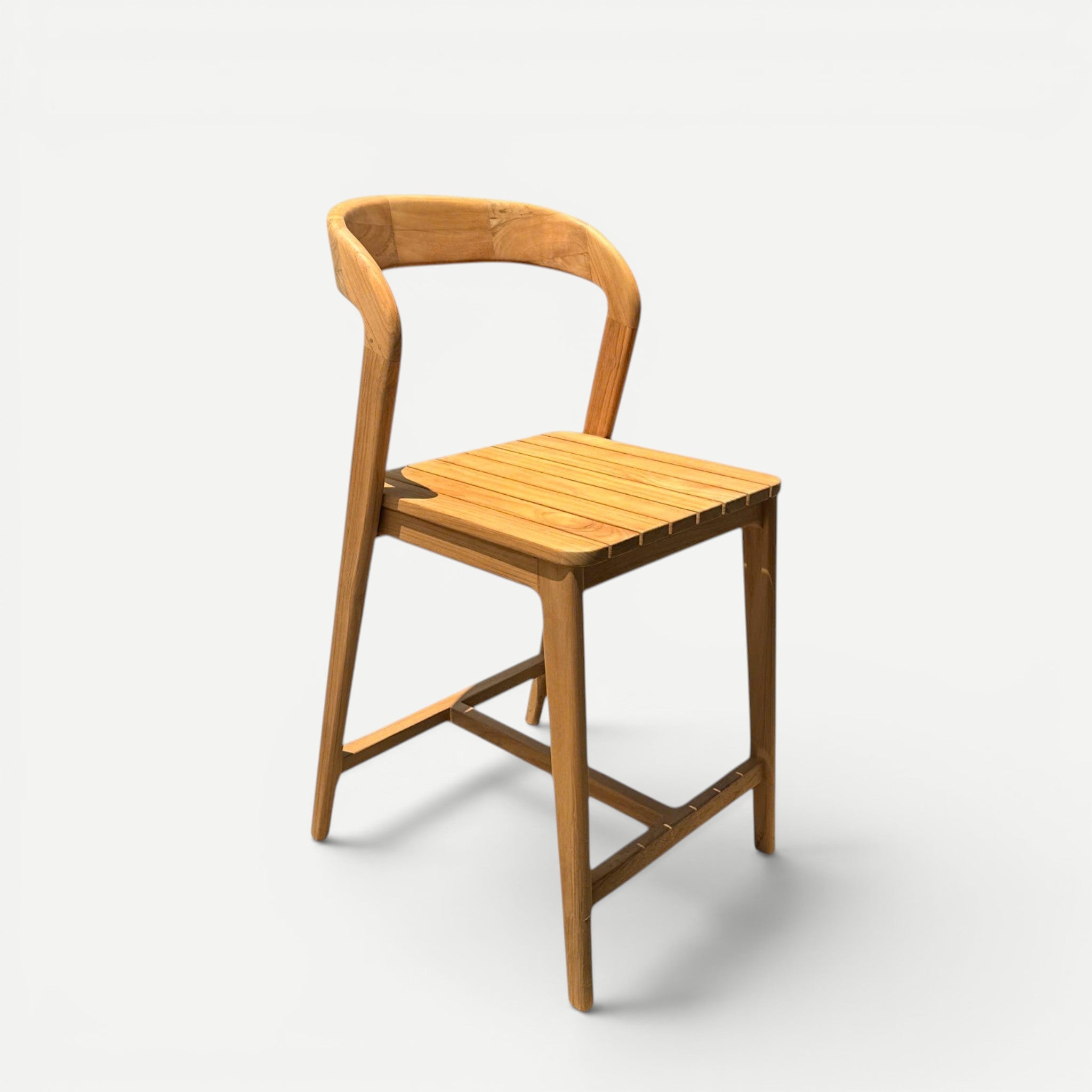 Hawaiian Discovery Furniture Noho teak counter stool with a slatted seat and curved backrest in natural wood finish.