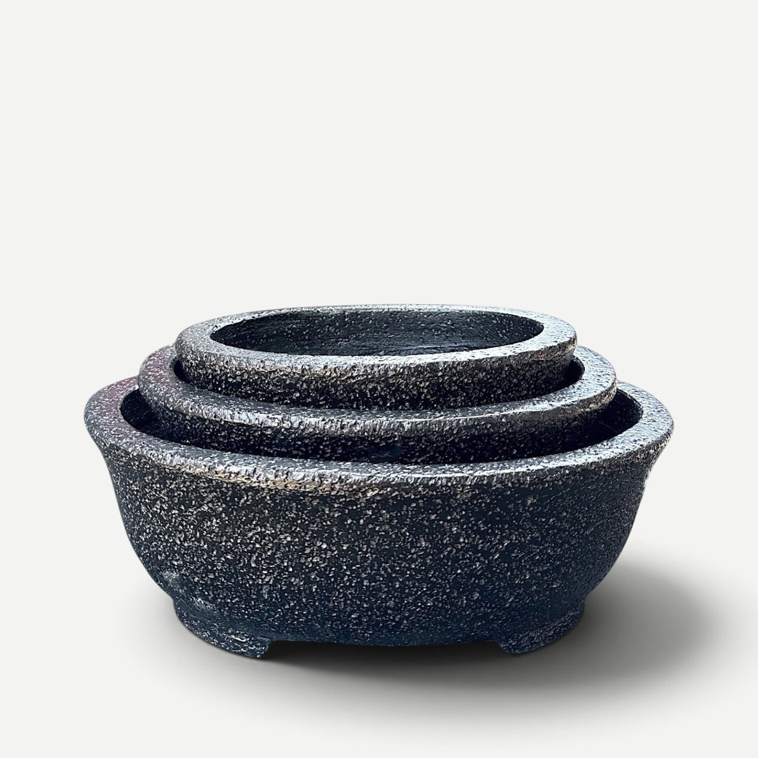 Hawaiian Discovery Furniture Kumo oval bonsai planters in a nested set with a textured dark grey concrete finish.