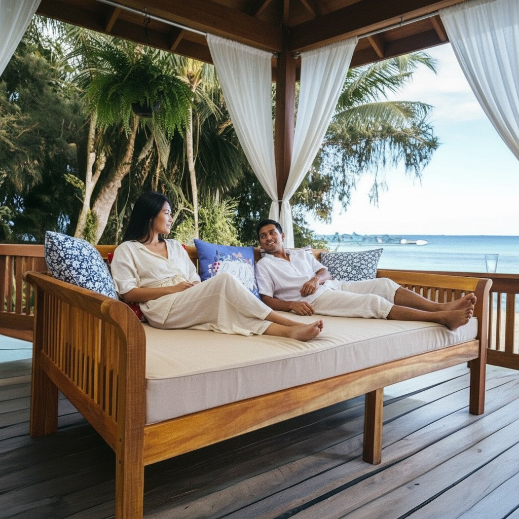 Hawaiian Discovery Furniture Riviera Daybed with taupe twin cushion on a tropical deck with a couple relaxing.