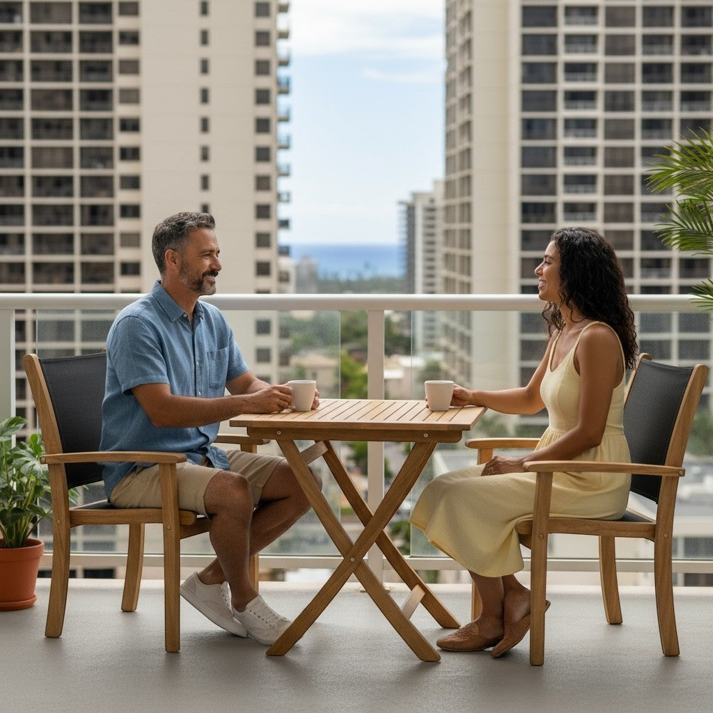 Hawaiian Discovery Furniture Kakahiaka teak bistro set with a square folding table and two chairs on a balcony.