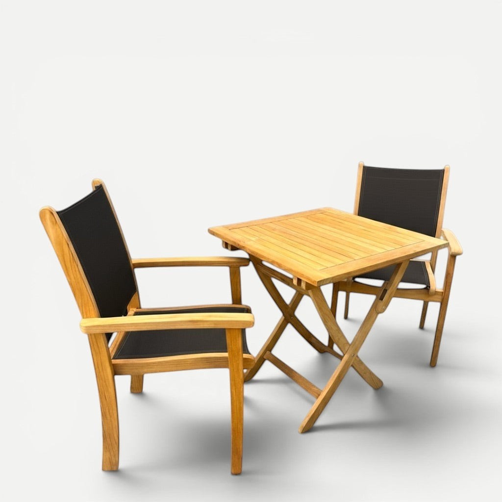 Hawaiian Discovery Furniture Kakahiaka set with two teak armchairs featuring black sling seats and a square folding table.