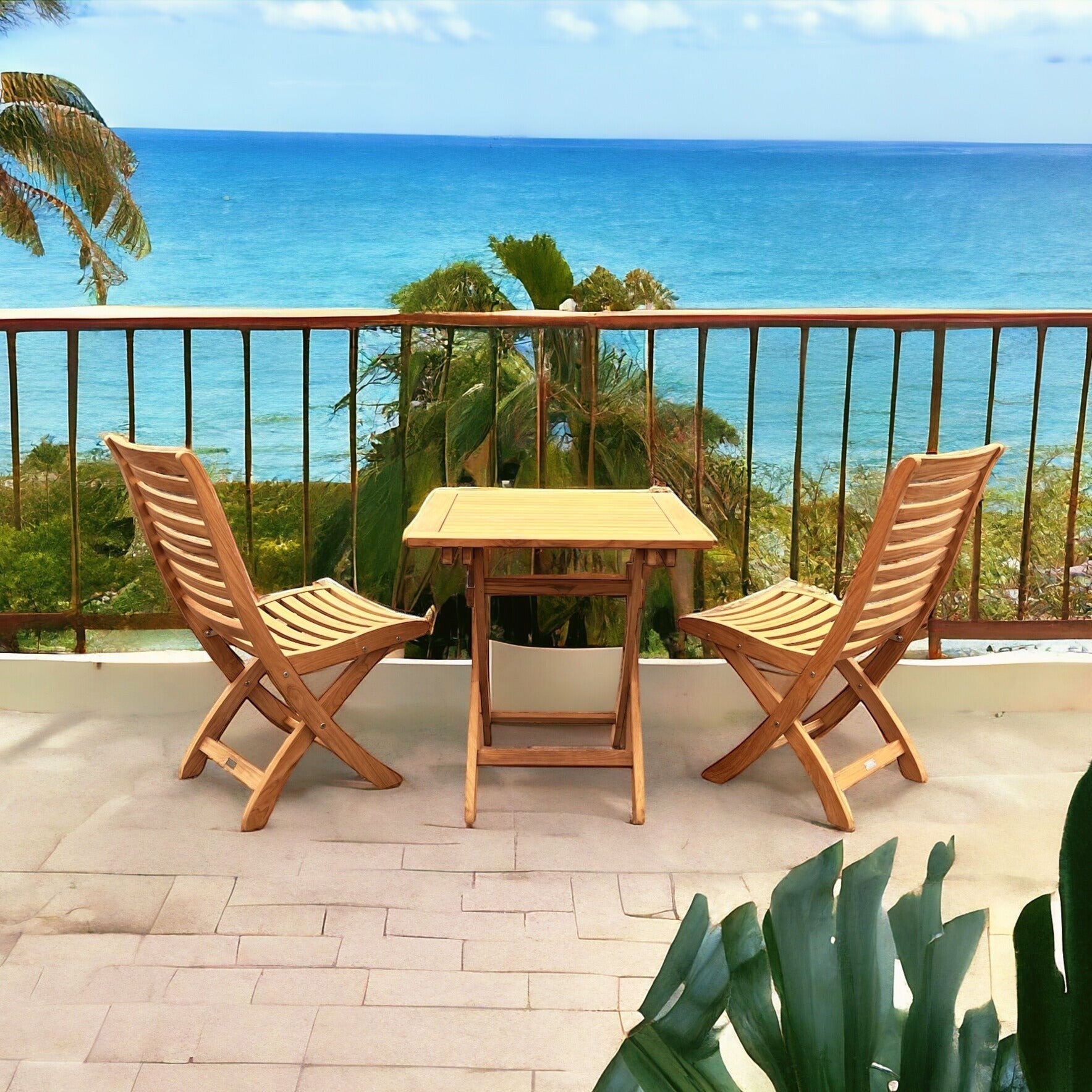 Hawaiian Discovery Furniture Kakahiaka teak patio set with two folding chairs and a square table on an ocean balcony.