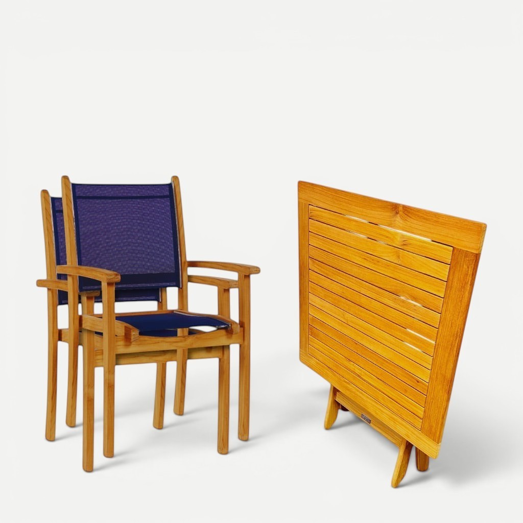 Hawaiian Discovery Furniture Kakahiaka set featuring two teak Pearl armchairs with blue slings and a folding table.