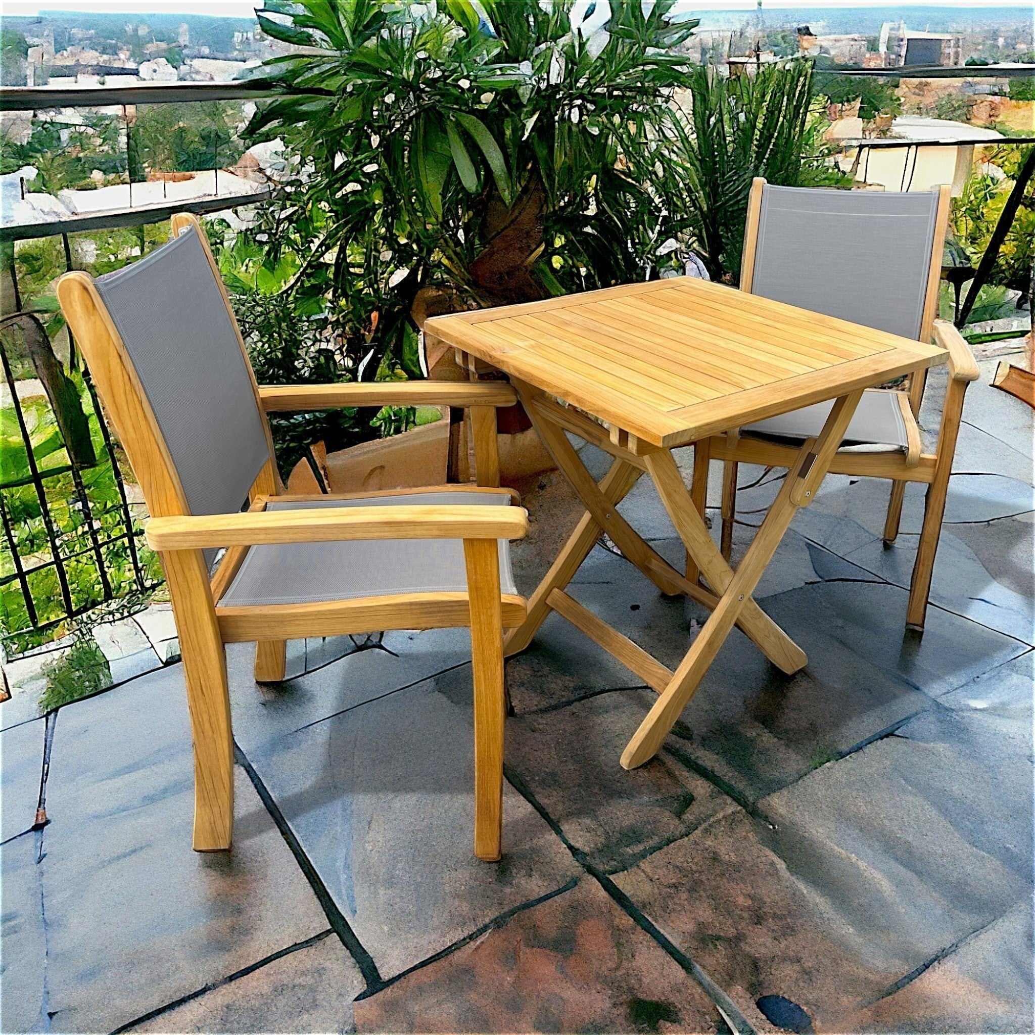 Hawaiian Discovery Furniture Kakahiaka set with two teak armchairs featuring grey sling seats and a square folding table.