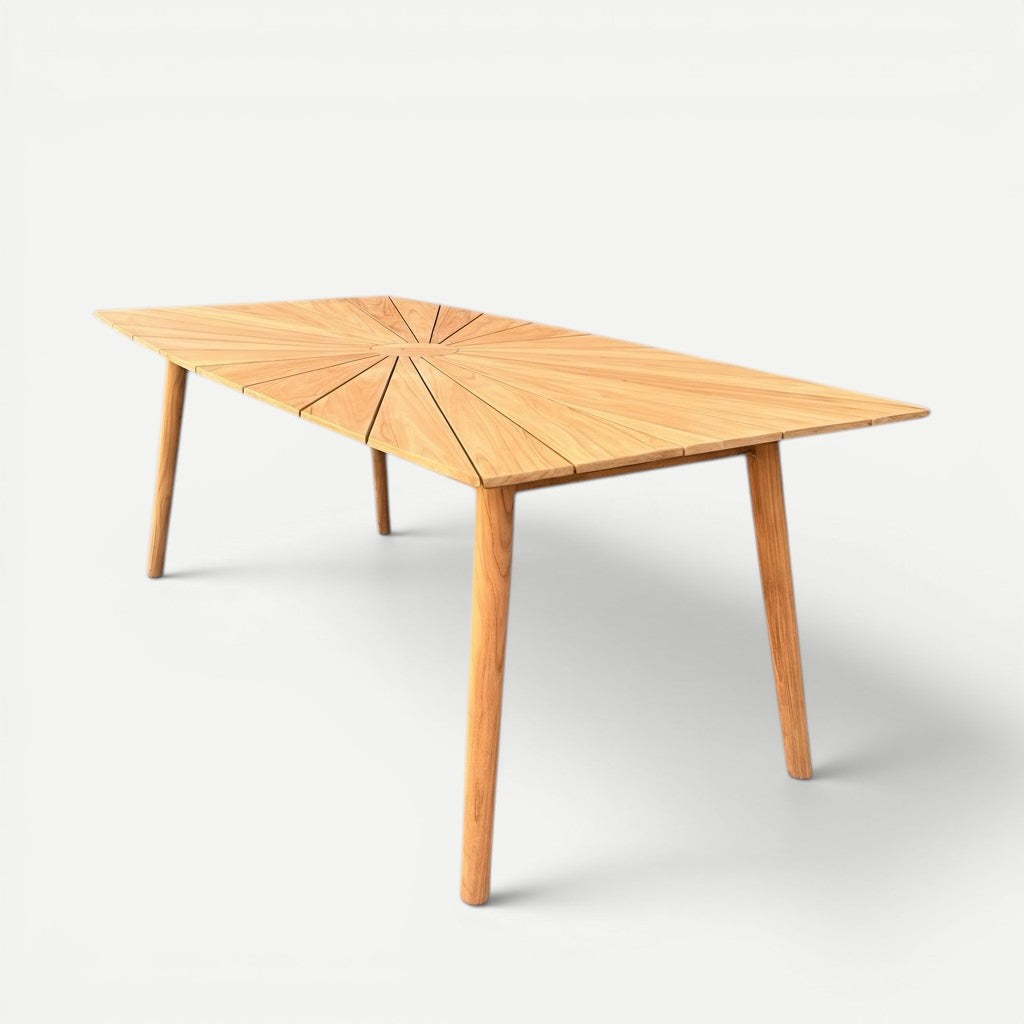 Hawaiian Discovery Furniture Cambria solid teak wood outdoor dining table with a sunburst pattern top and tapered legs