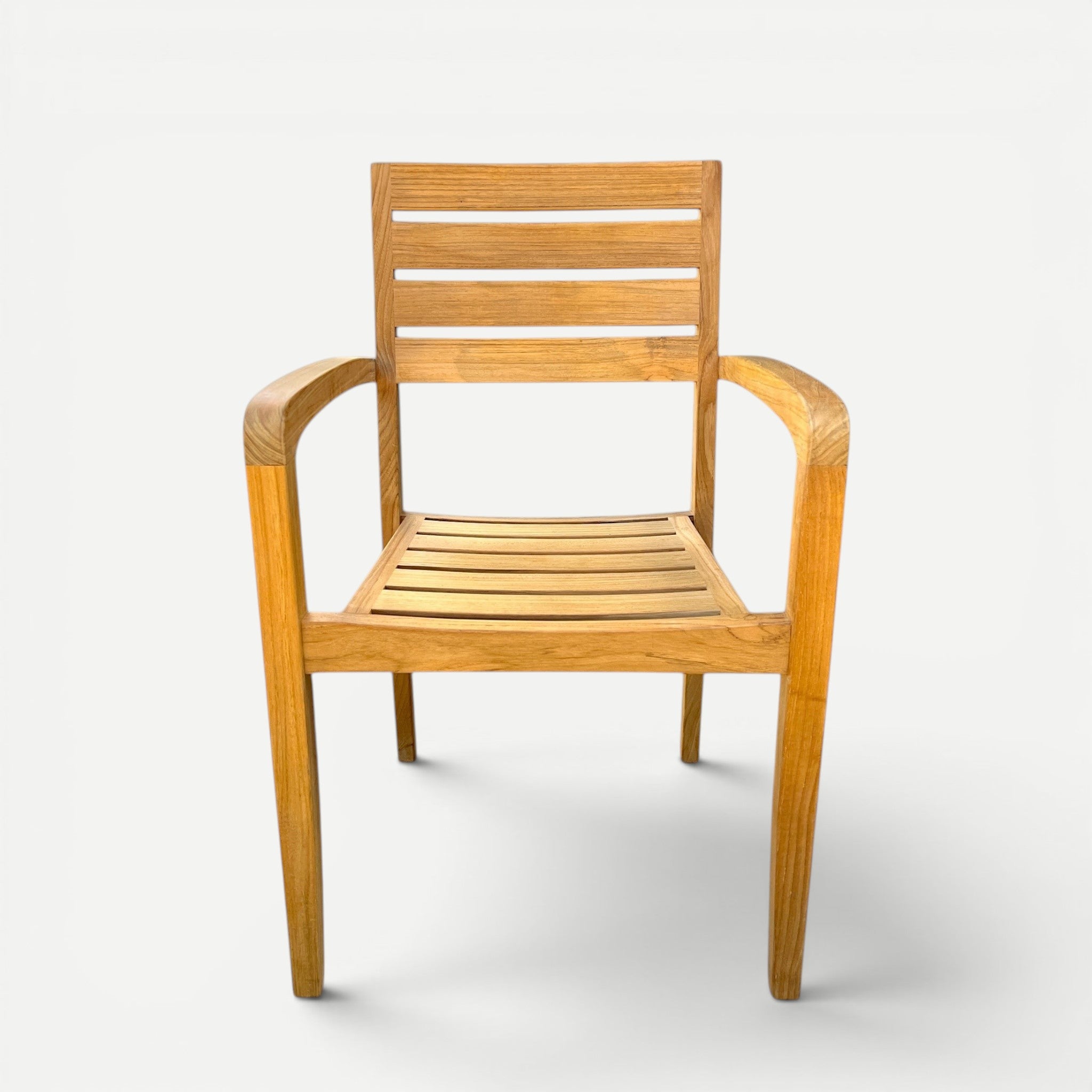 Hawaiian Discovery Furniture Venice teak outdoor arm chair with a slatted back and seat in a natural golden finish.