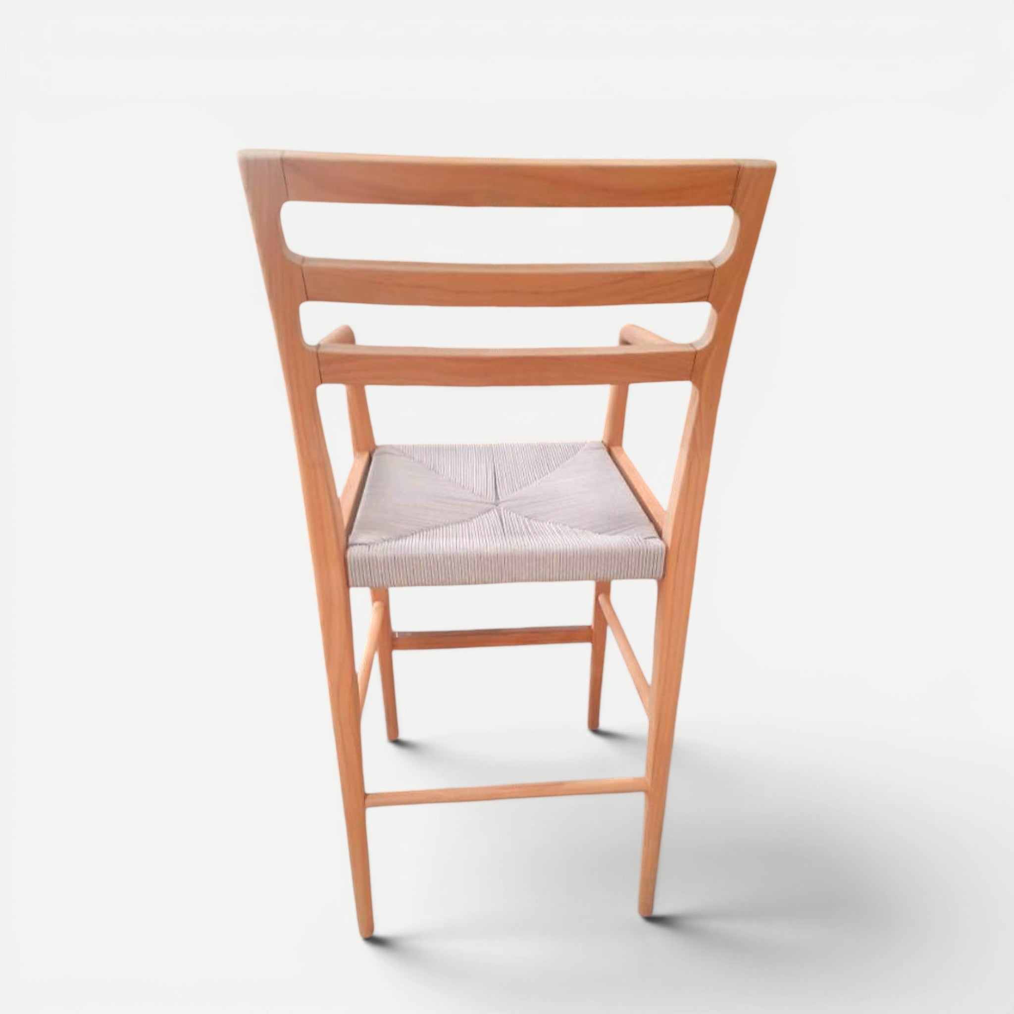 Hawaiian Discovery Furniture Wailea teak barstool with a handwoven seat and sculpted armrests, back view.