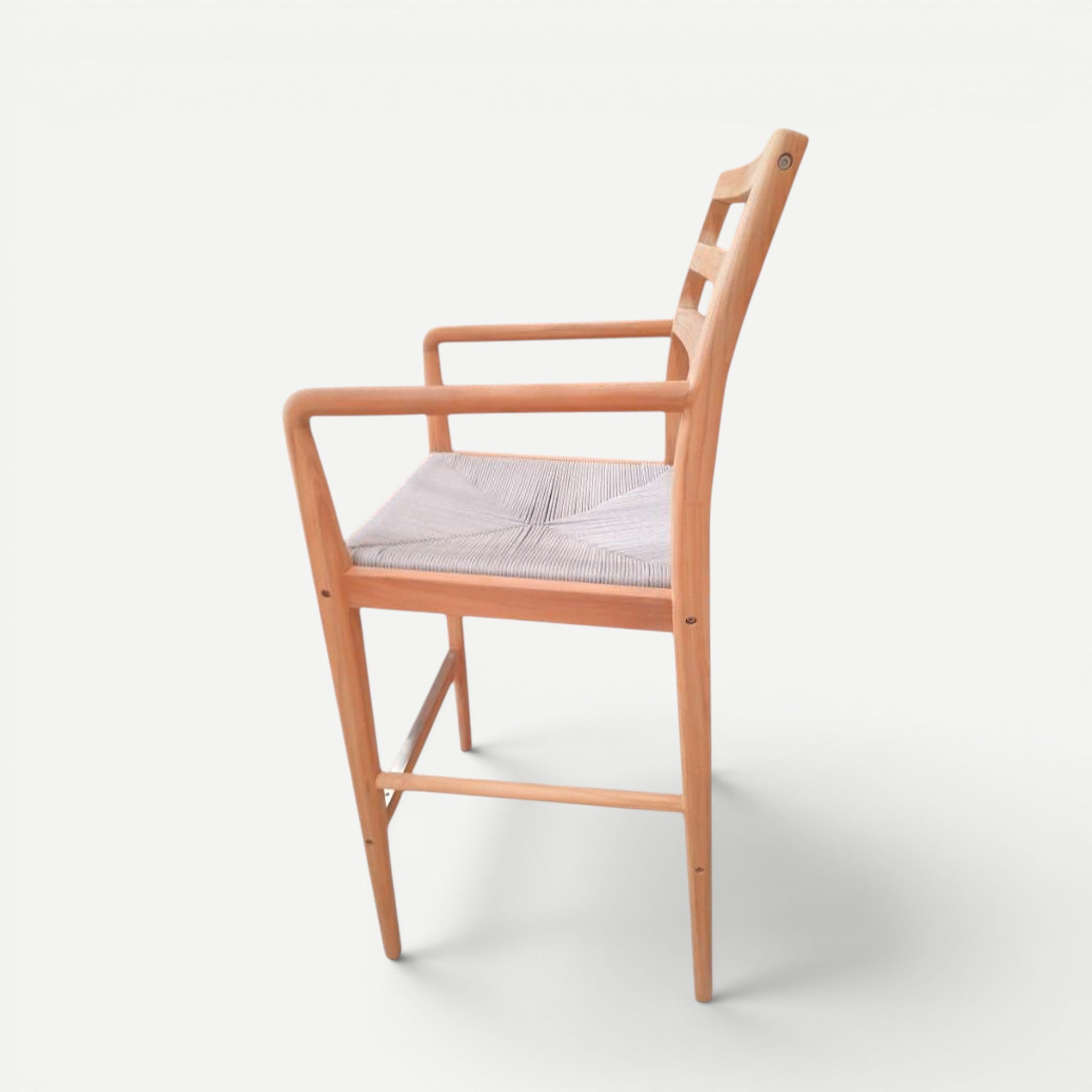 Hawaiian Discovery Furniture Wailea teak barstool with a handwoven seat, sculpted armrests, and a sturdy wooden frame.