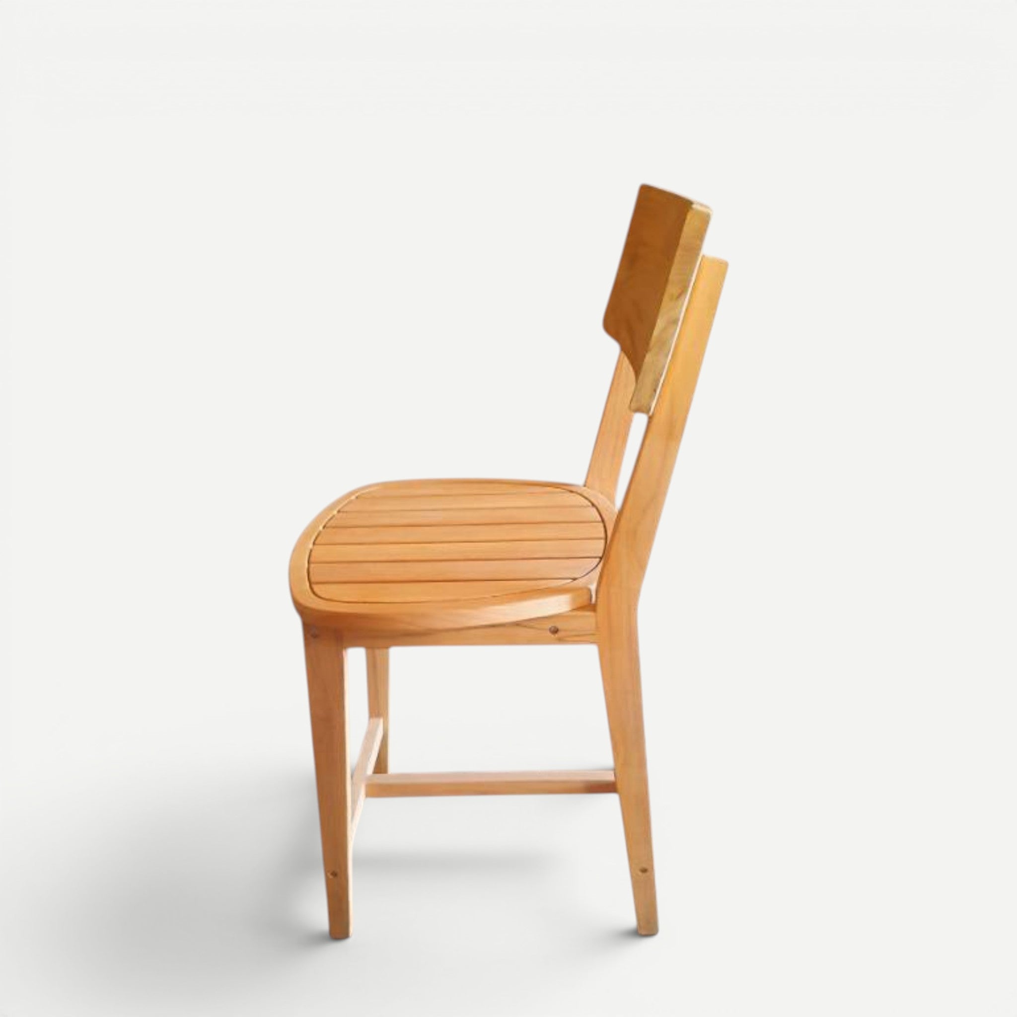Hawaiian Discovery Furniture Wailuku teak counter stool in a natural golden wood finish, side view.
