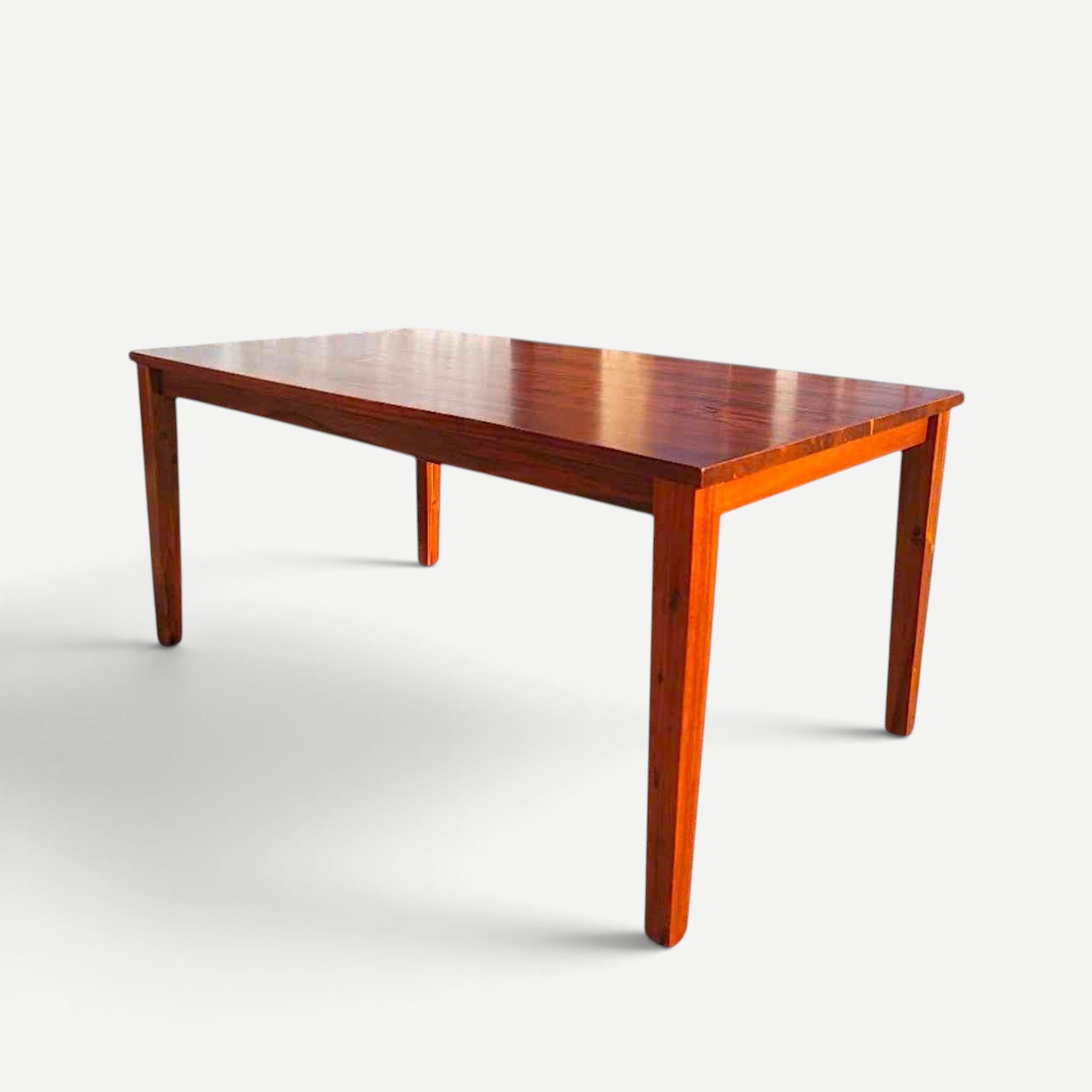 Hawaiian Discovery Furniture Molokai 6-seater dining table made of rich brown acacia wood with a faux live edge.