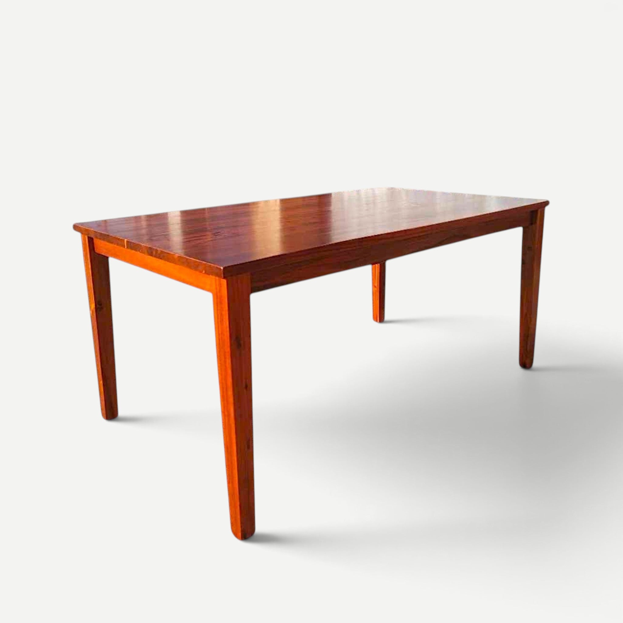 Hawaiian Discovery Furniture Molokai 6-seater dining table in rich brown acacia wood with a faux live edge design.