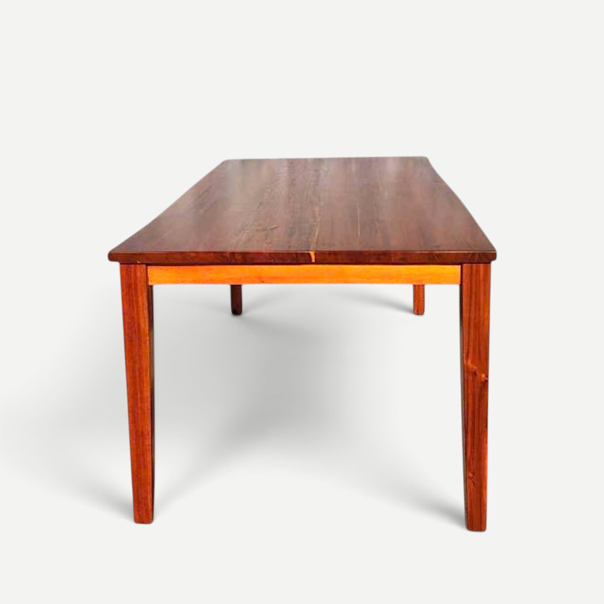 Hawaiian Discovery Furniture Molokai 6-seater dining table made of rich brown acacia wood with a faux live edge design.