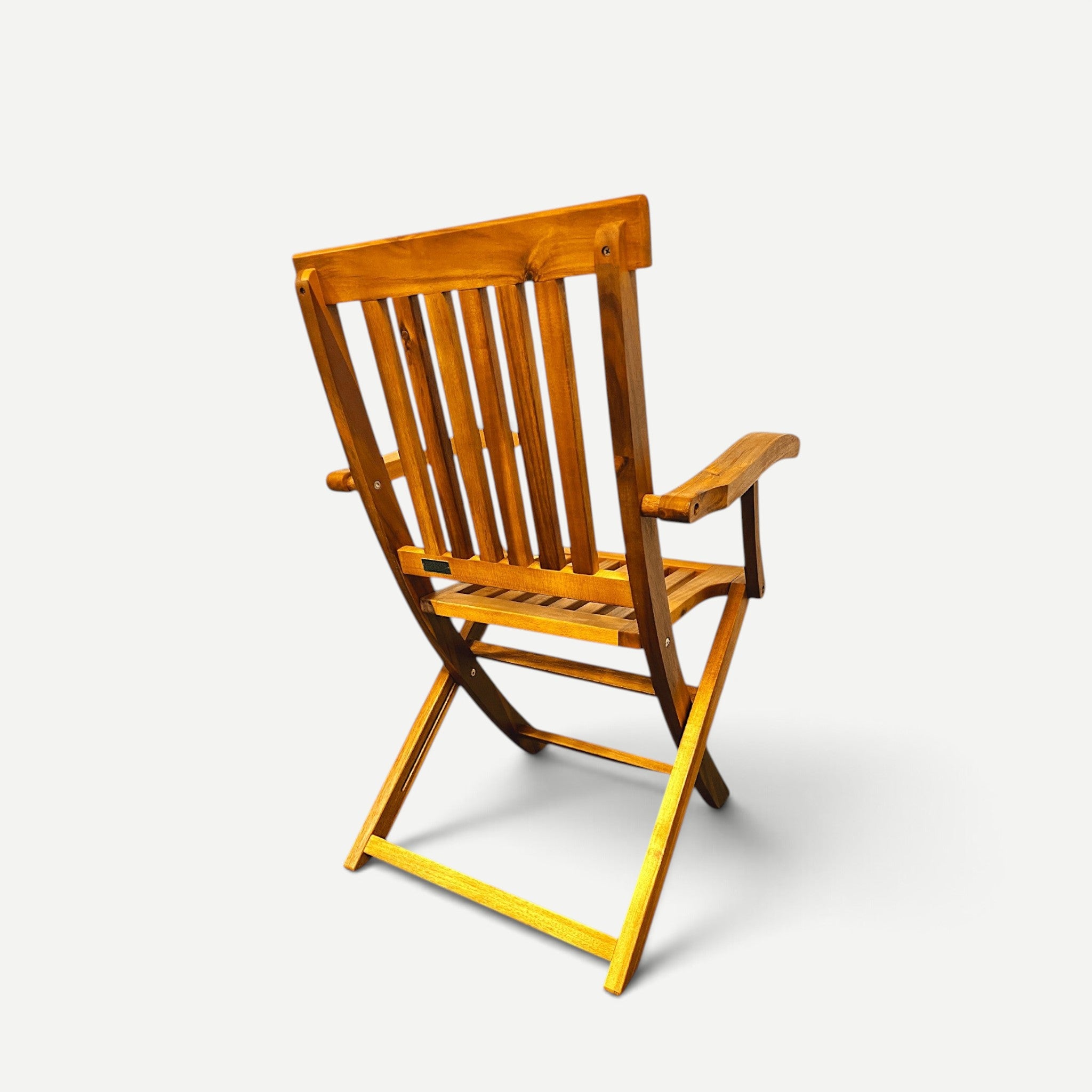 Hawaiian Discovery Furniture Hanalei folding armchair made of natural acacia wood, shown from a rear angle.