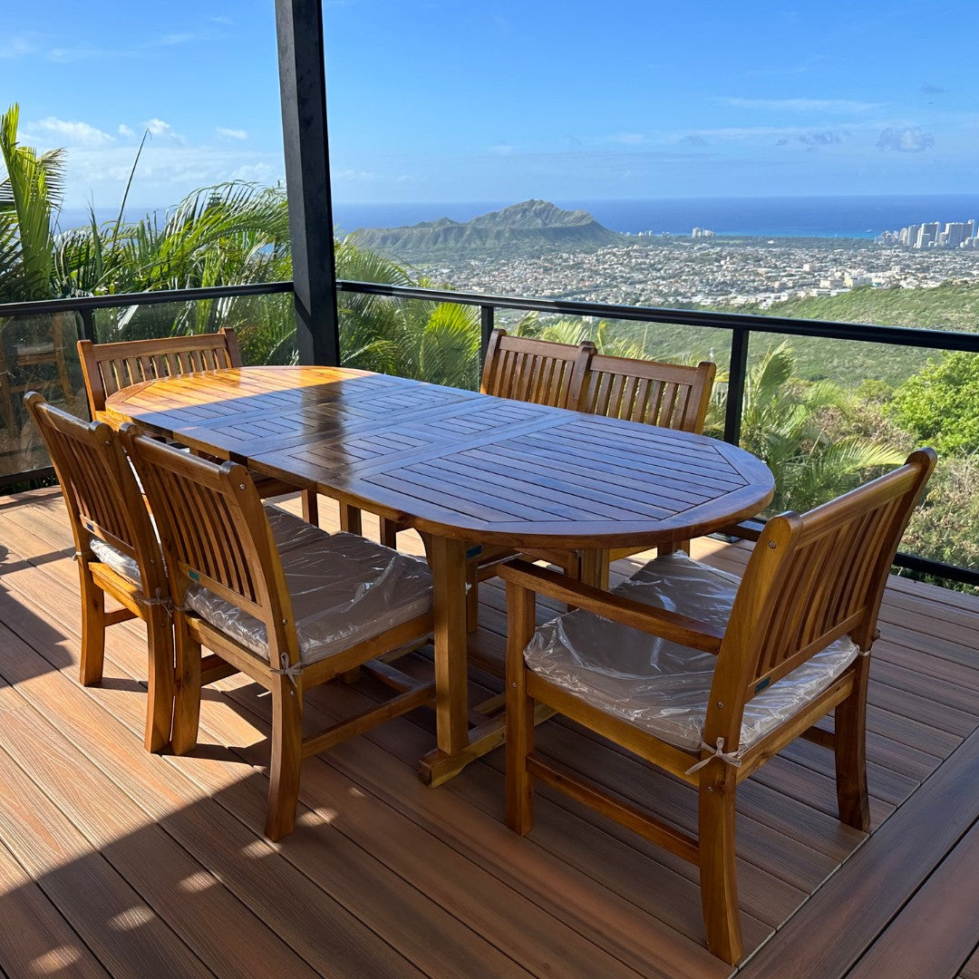 Hawaiian Discovery Furniture acacia wood oval extension table with chairs on a deck overlooking Diamond Head crater.