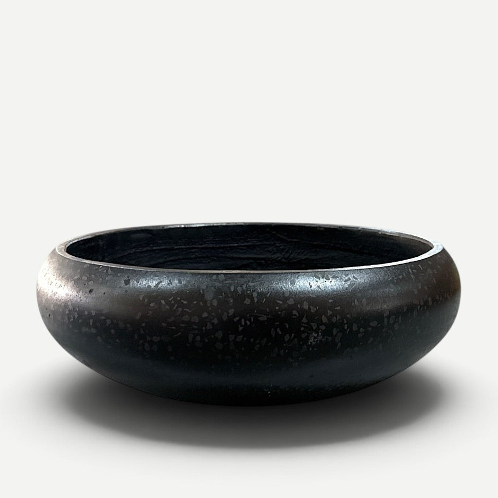 Hawaiian Discovery Furniture Calabash terrazzo planter in a smooth black finish with subtle stone flecks.