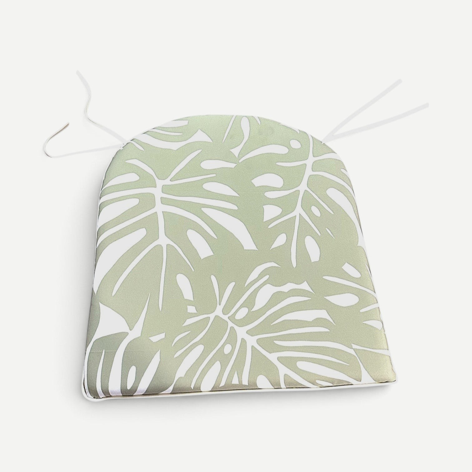 Hawaiian Discovery Furniture polyester chair pad with a light green monstera leaf pattern for Haleiwa dining chairs