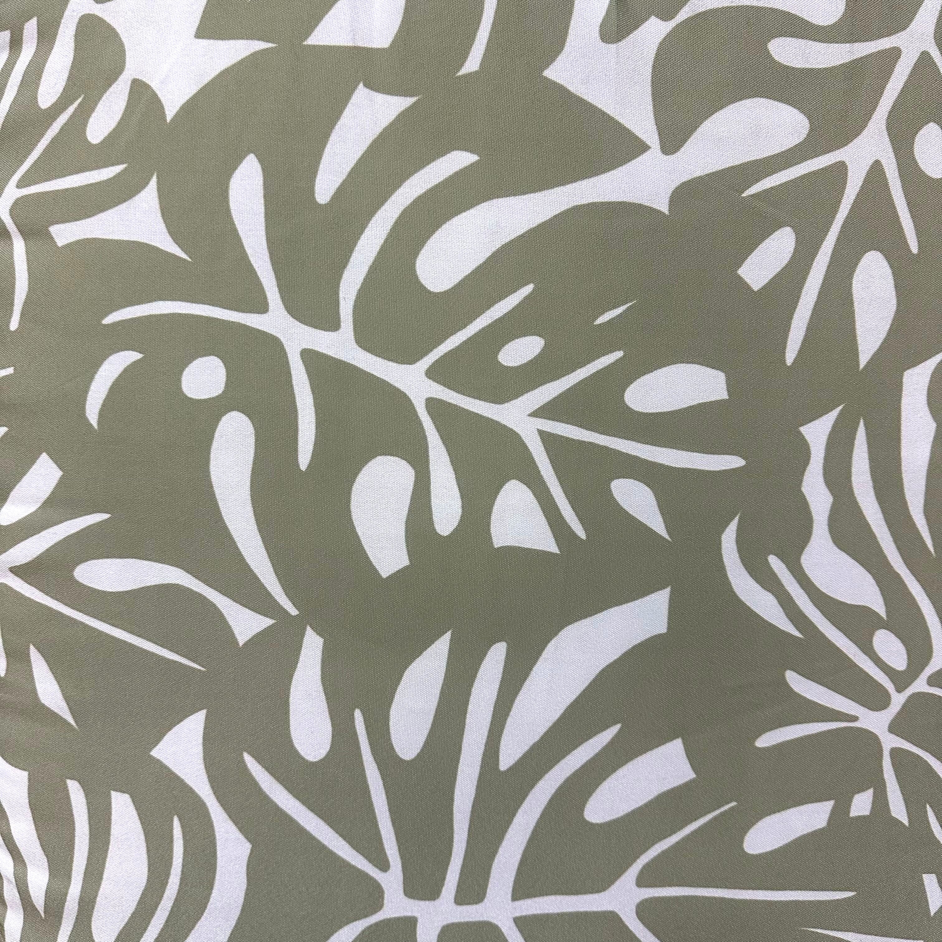 Hawaiian Discovery Furniture polyester chair pad fabric with a green and white tropical monstera leaf pattern