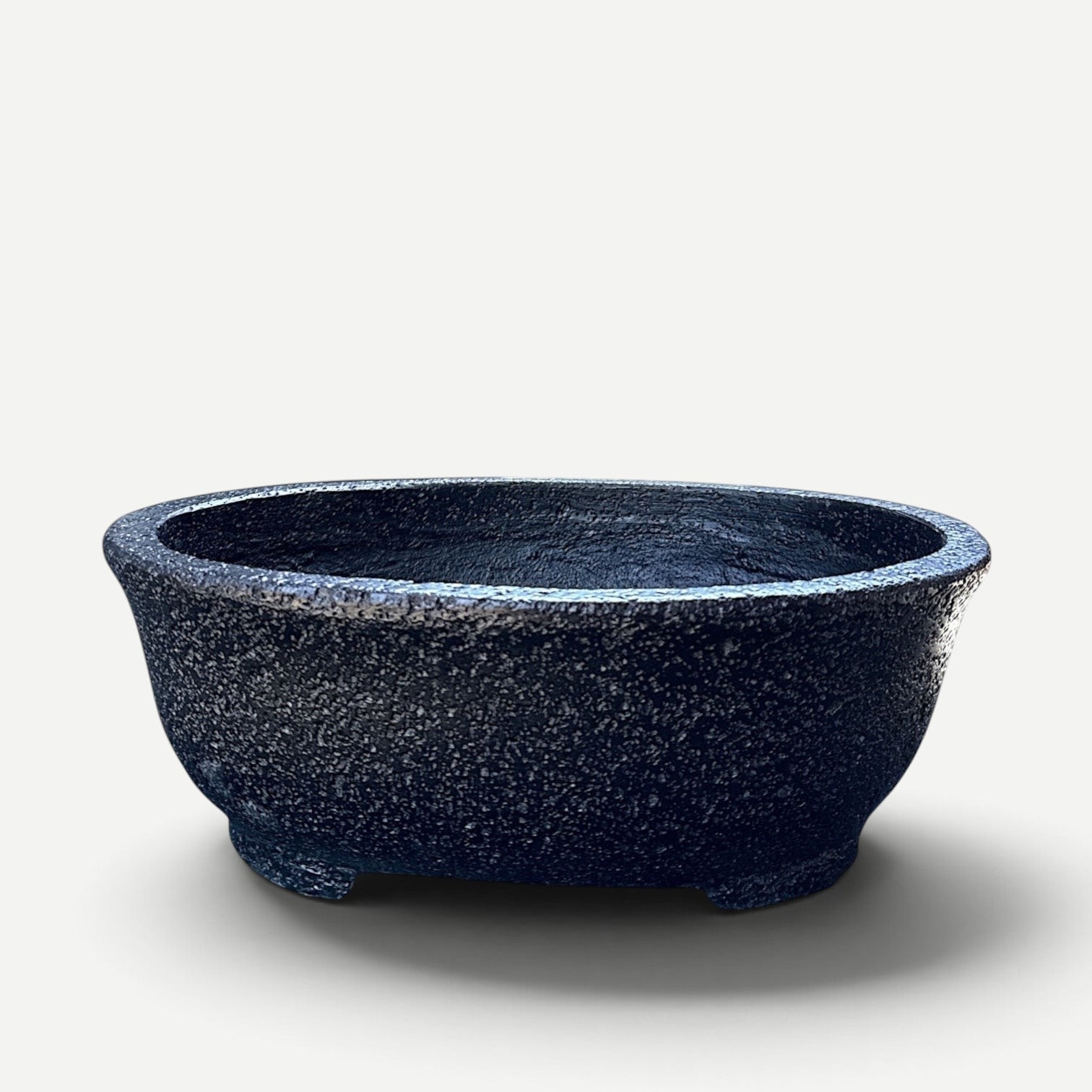Hawaiian Discovery Furniture Kumo oval bonsai planter made of lightweight concrete and recycled foam in dark grey.