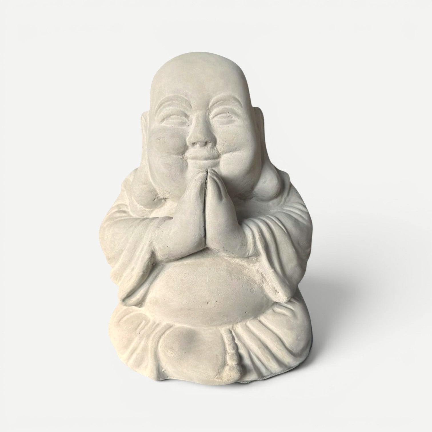 Hawaiian Discovery Furniture praying Buddha statue with a soft stone finish and joyful expression in a gratitude pose.
