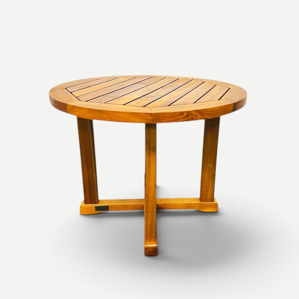 Hawaiian Discovery Furniture round side table made of natural acacia wood with a slatted top and sturdy cross base.