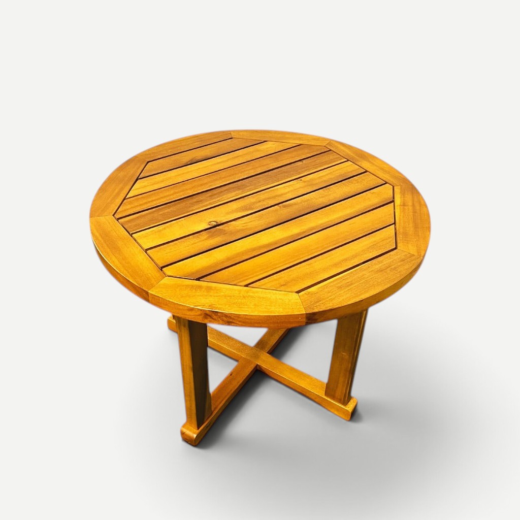 Hawaiian Discovery Furniture round side table made of natural plantation-grown acacia wood with a cross-leg base.