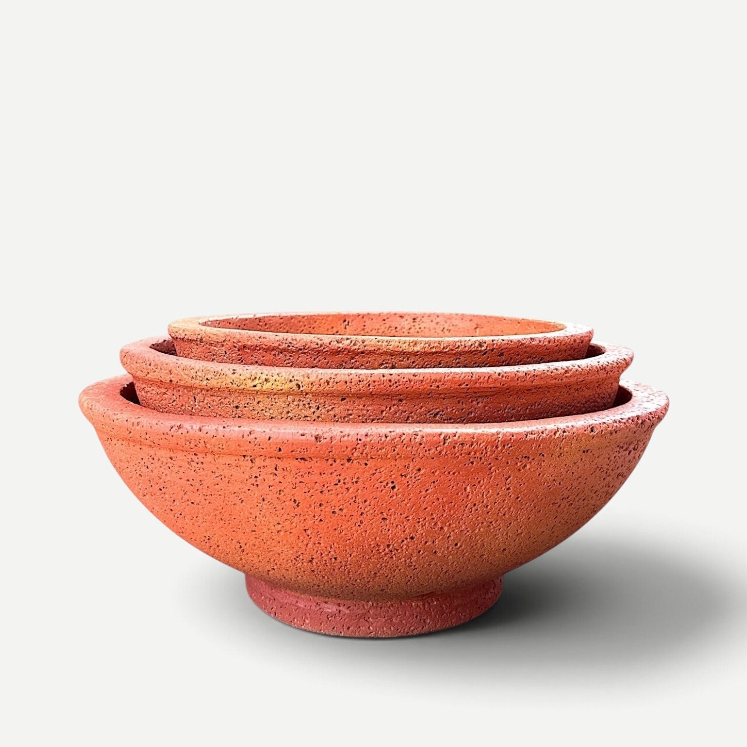 Hawaiian Discovery Furniture Maru round bonsai planters in terracotta red, crafted from lightweight foam and concrete.