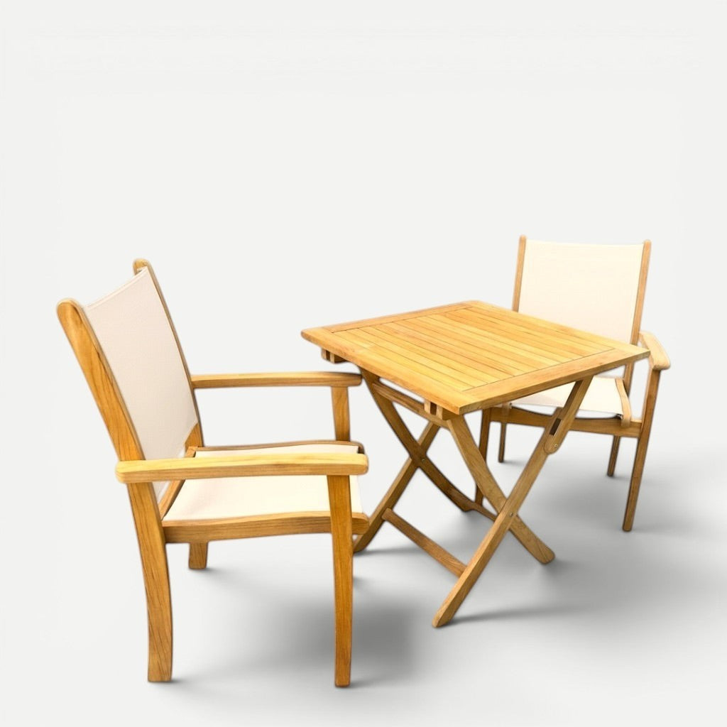 Hawaiian Discovery Furniture Kakahiaka set featuring two teak armchairs with off-white slings and a square folding table.