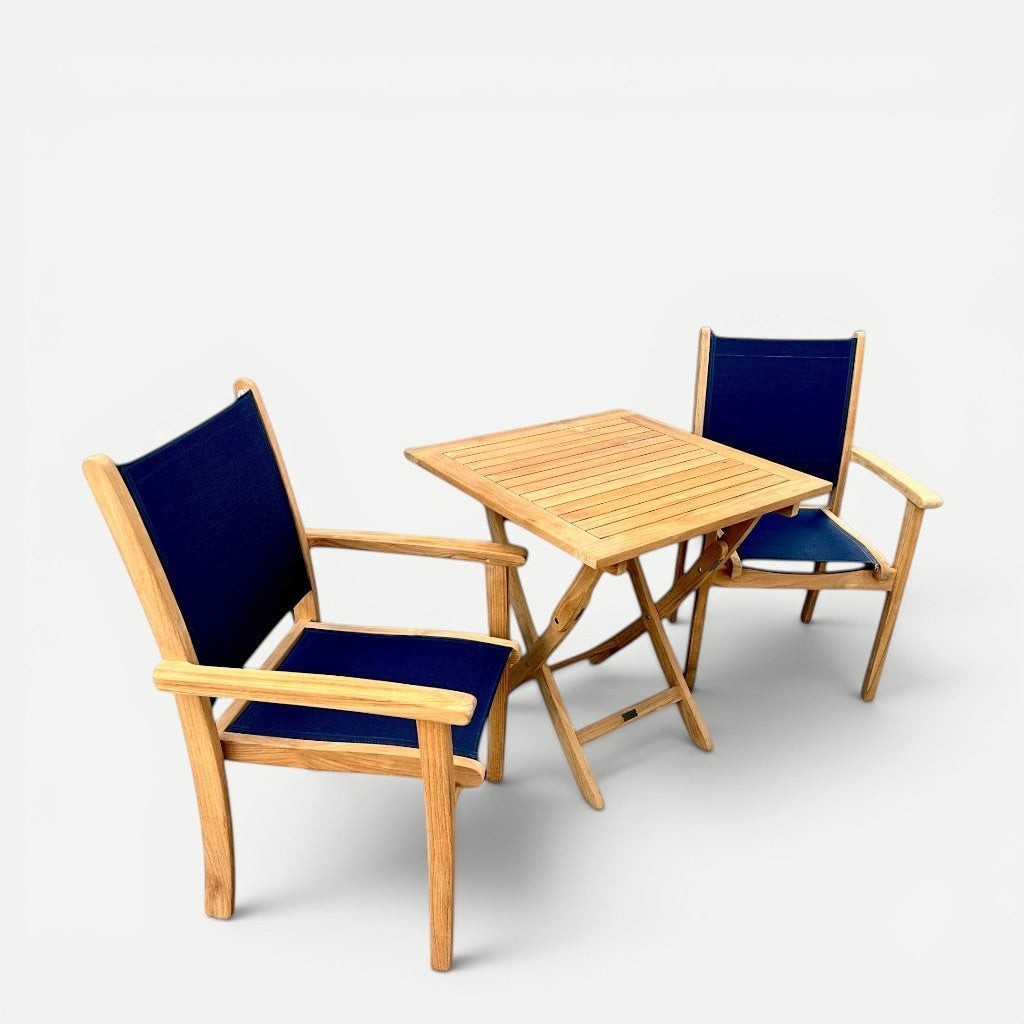 Hawaiian Discovery Furniture Kakahiaka set featuring two teak armchairs with blue sling fabric and a square folding table
