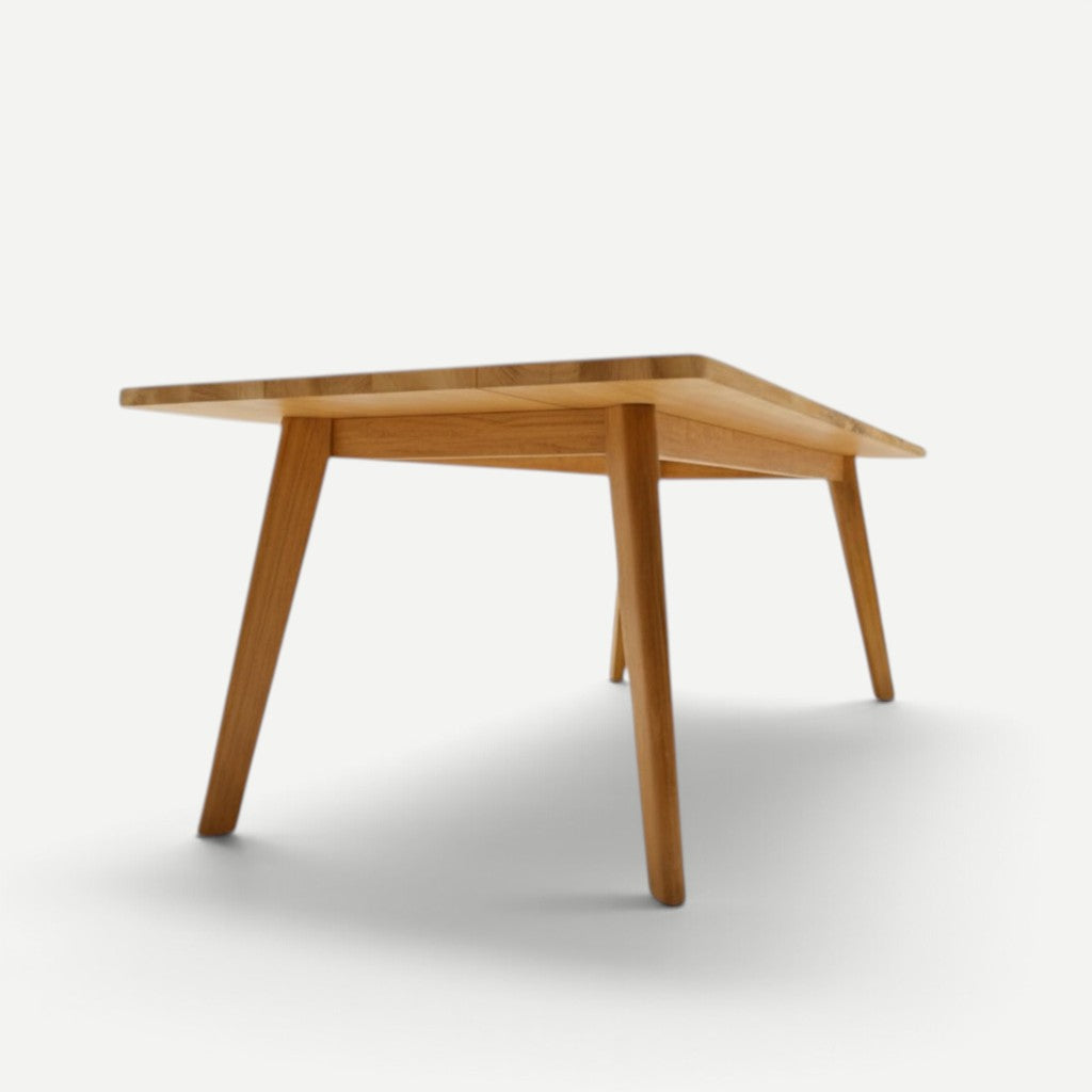 Hawaiian Discovery Furniture La Costa teak outdoor dining table with angled legs and a wide rectangular plank top.