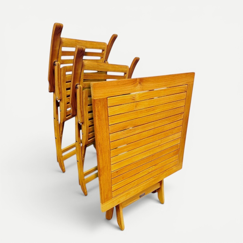 Hawaiian Discovery Furniture Kakahiaka set featuring two folded teak chairs and a square folding table in honey wood.
