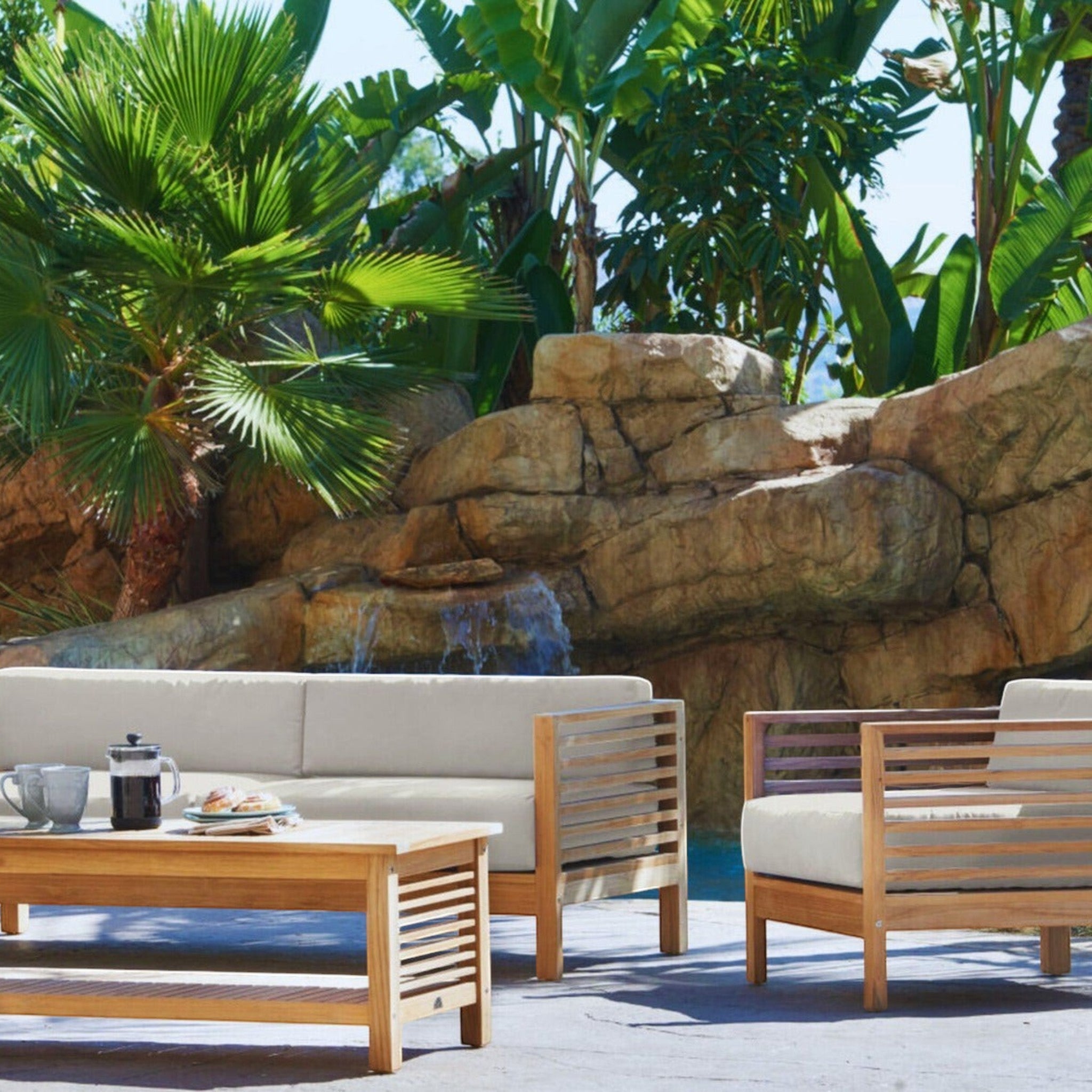 Hawaiian Discovery Furniture Summer Loveseat set with teak wood frame and taupe olefin cushions on a patio.