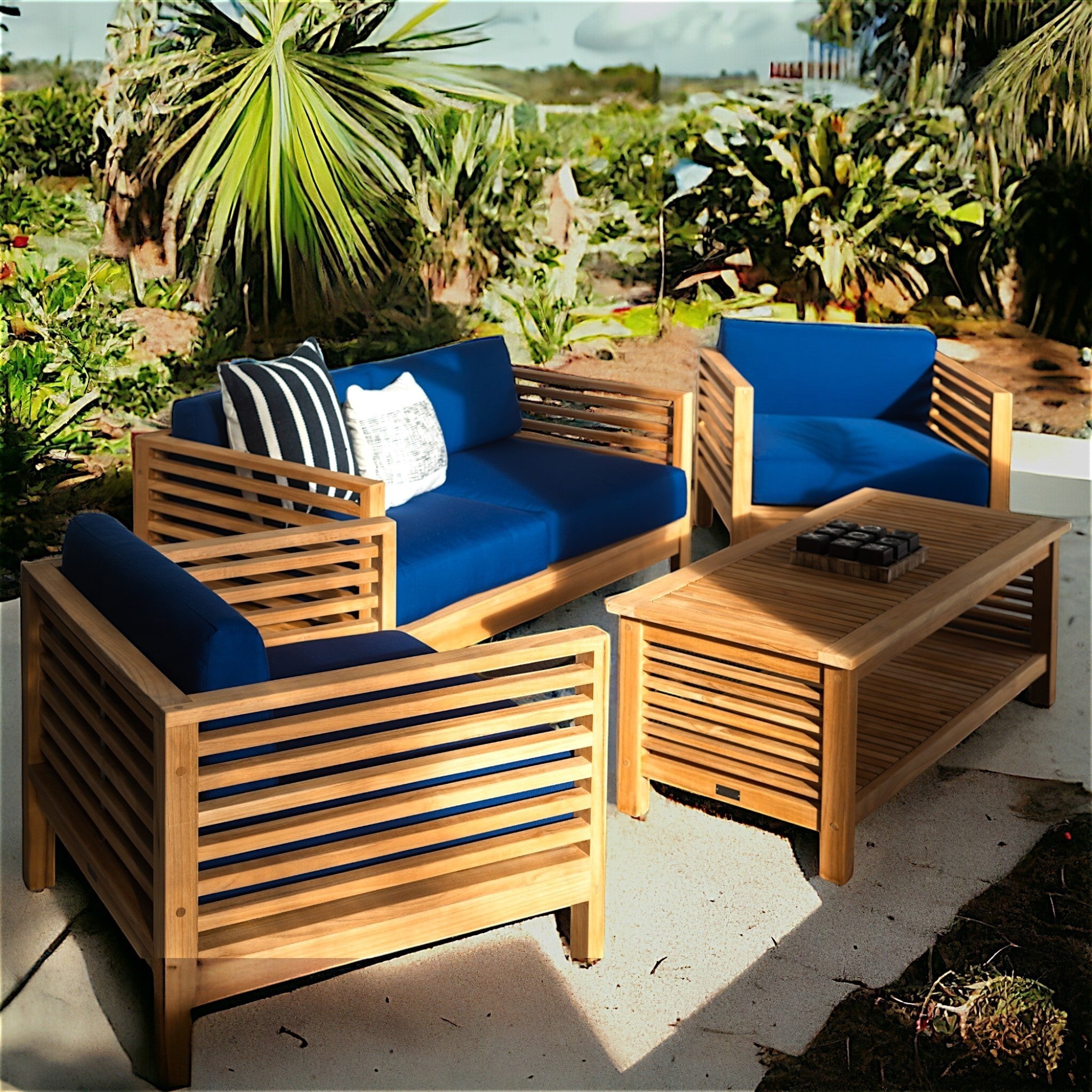 Hawaiian Discovery Furniture Summer Loveseat set with teak wood frames and blue cushions on a patio.