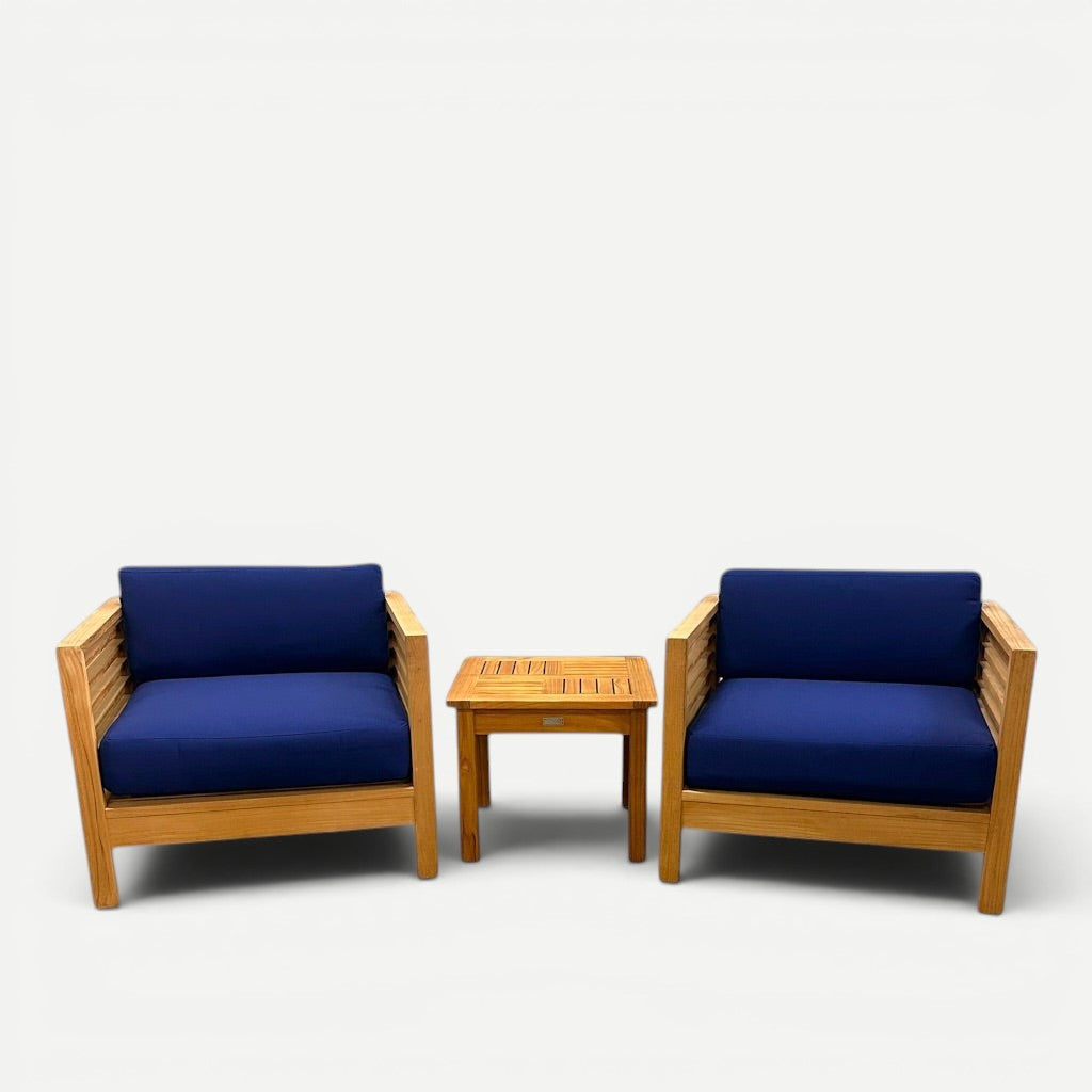 Hawaiian Discovery Furniture Summer Small Area Set with two teak club chairs and a Dane side table with blue cushions.