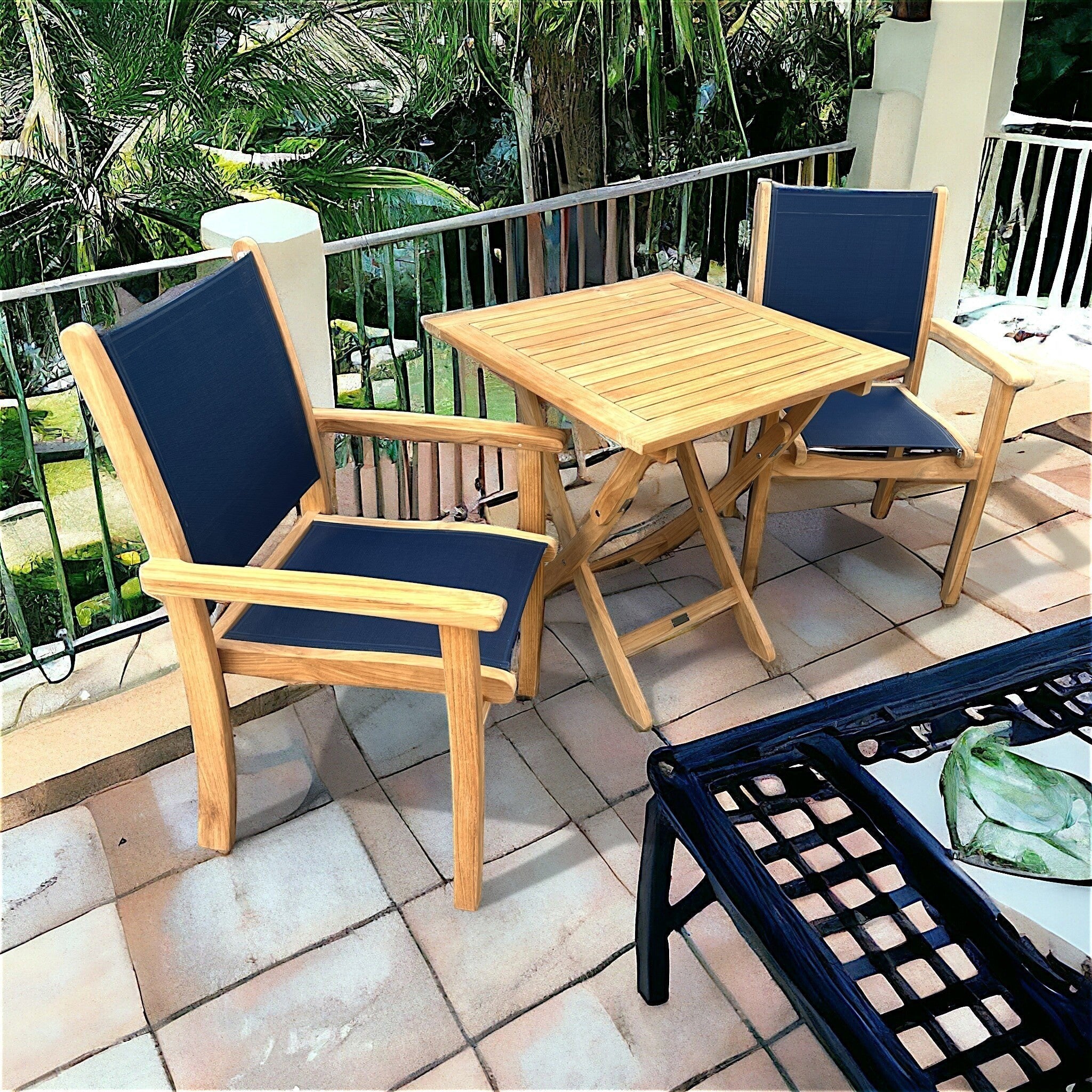Hawaiian Discovery Furniture Kakahiaka set featuring two teak Pearl arm chairs with blue slings and a square folding table.
