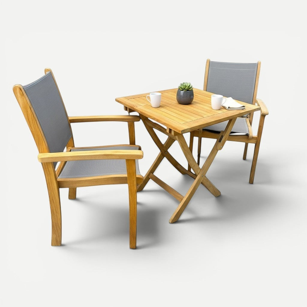 Hawaiian Discovery Furniture Kakahiaka teak patio set with a square folding table and two grey sling armchairs.