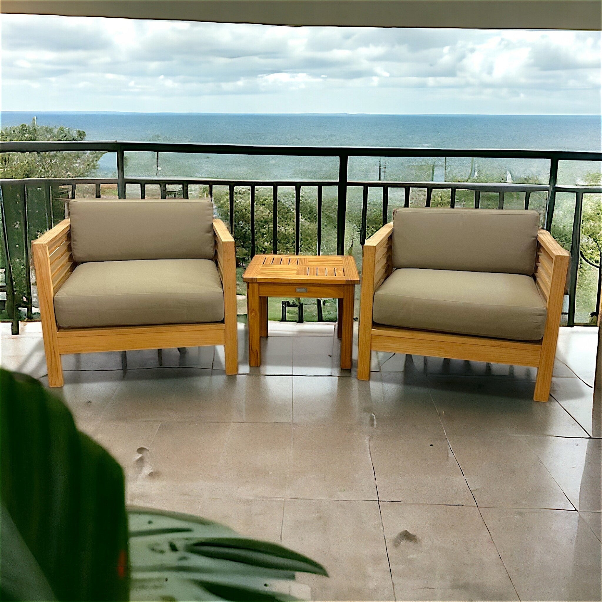 Hawaiian Discovery Furniture Summer Small Area Set with two teak club chairs and a side table on an oceanfront patio.