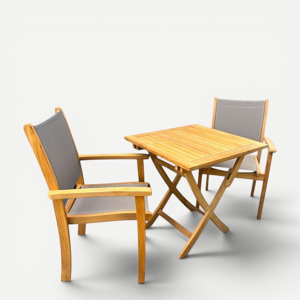 Hawaiian Discovery Furniture Kakahiaka set featuring two teak armchairs with grey sling seats and a folding square table