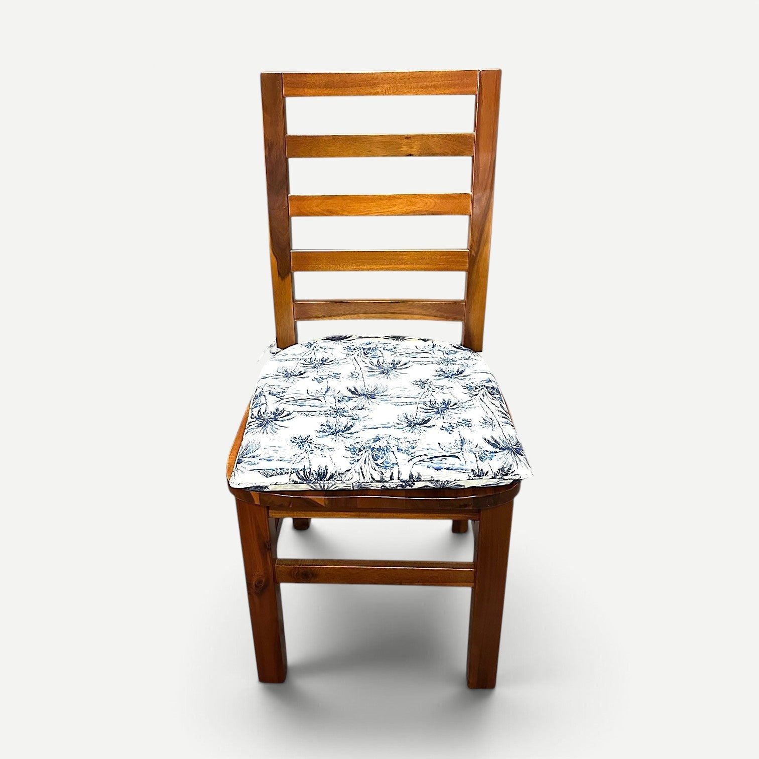 Hawaiian Discovery Furniture chair pad with blue and white tropical pattern on a wooden dining chair