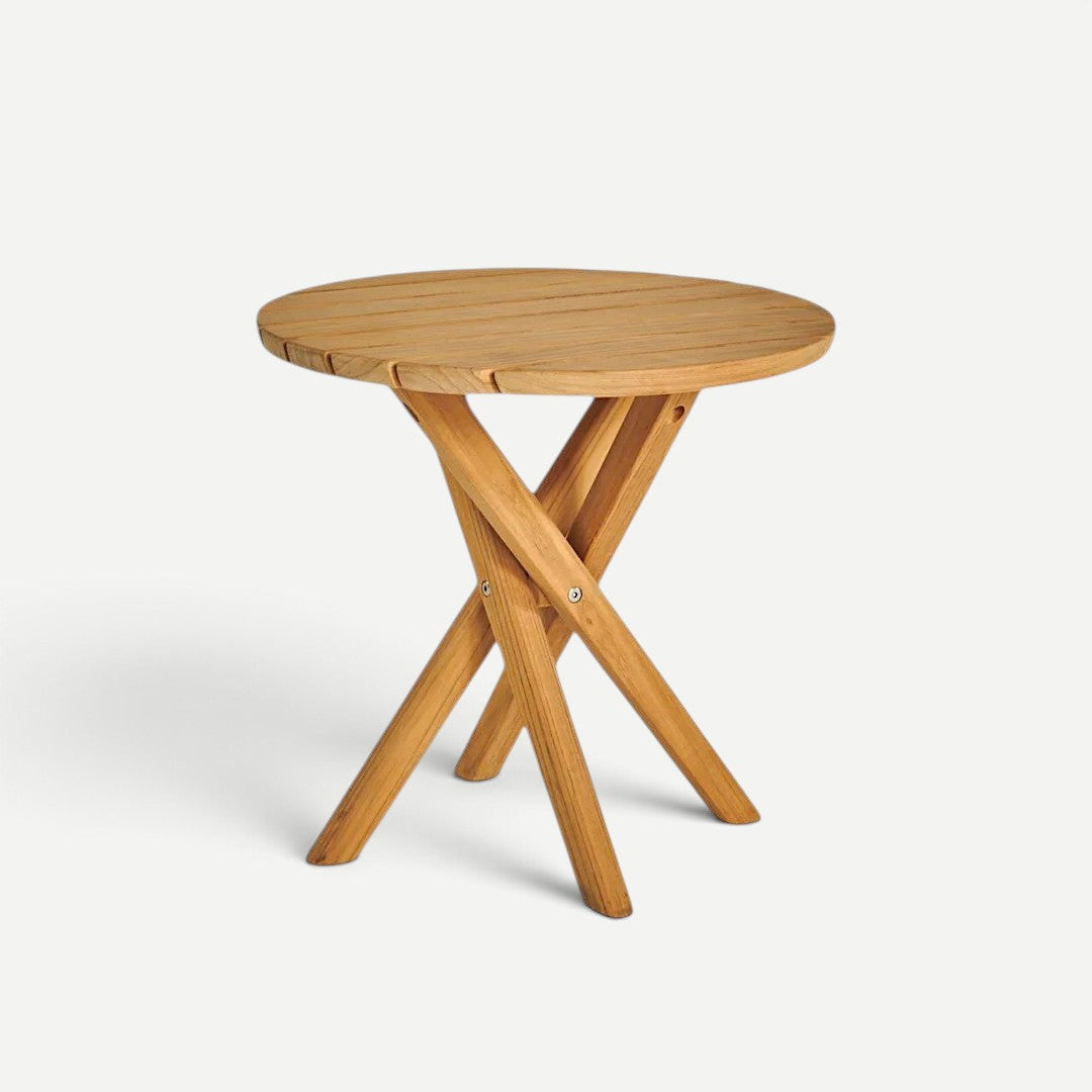 Hawaiian Discovery Furniture Tulum teak side table with a round top and sturdy crossed-leg design in golden wood.