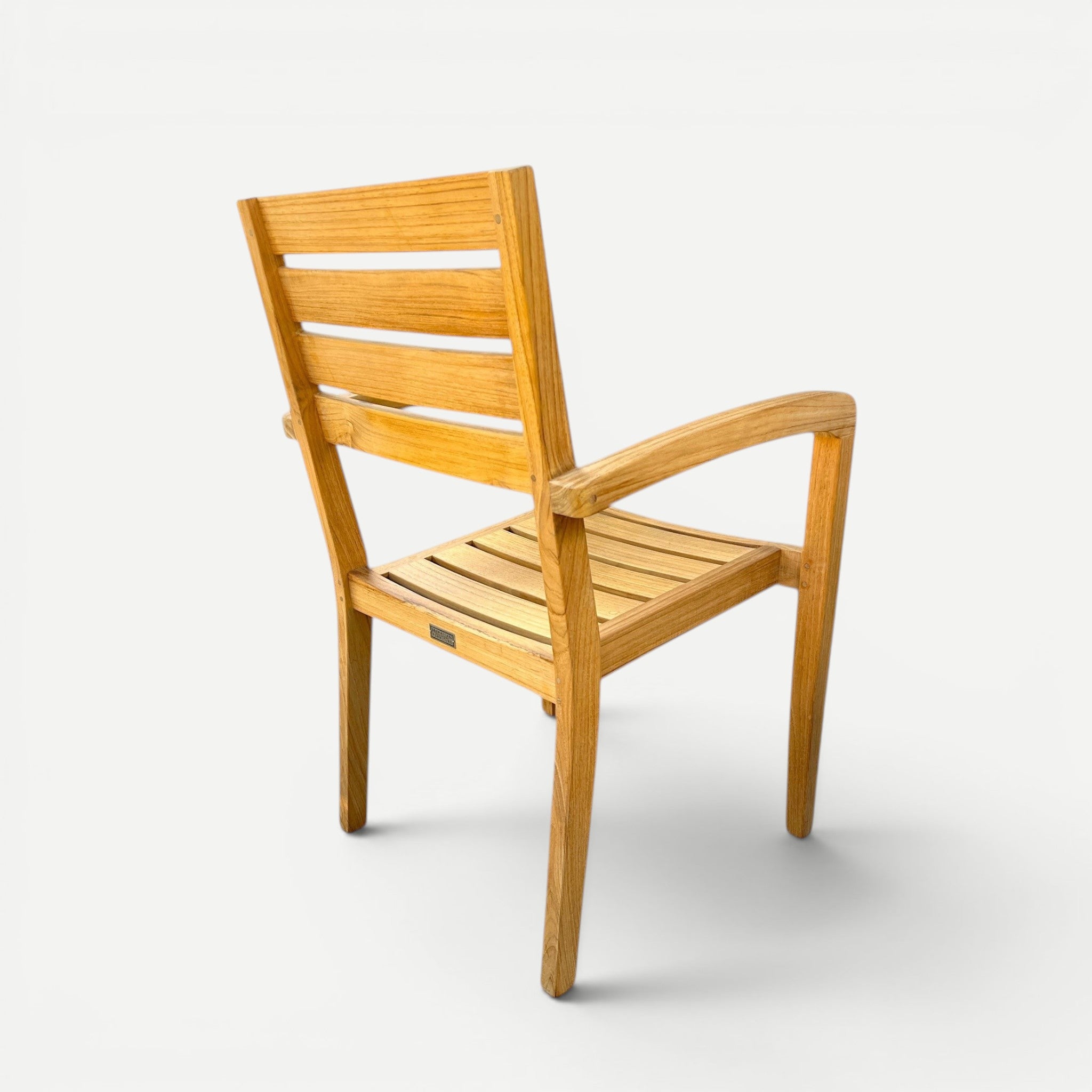 Hawaiian Discovery Furniture Venice teak outdoor arm chair with a slatted back and natural golden wood finish.