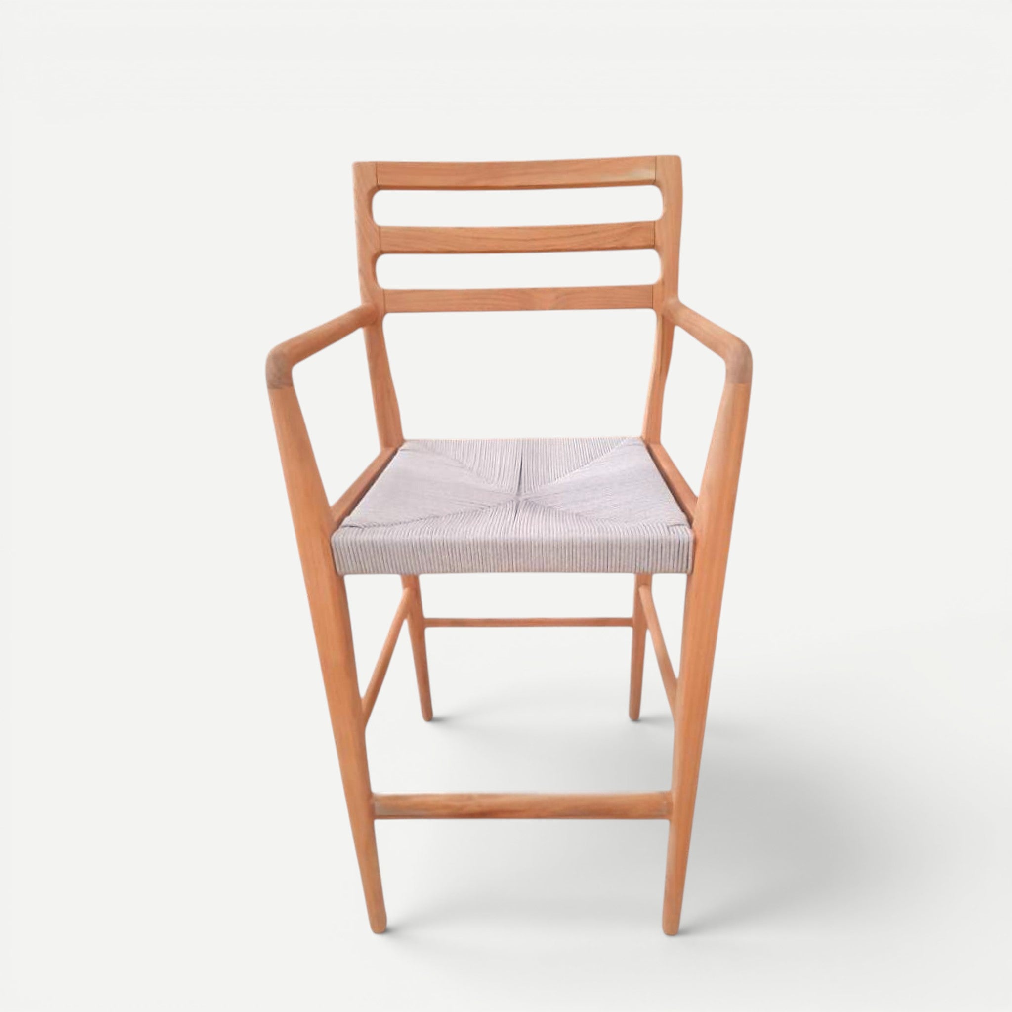 Hawaiian Discovery Furniture Wailea teak barstool with a handwoven seat, sculpted armrests, and a natural wood finish.