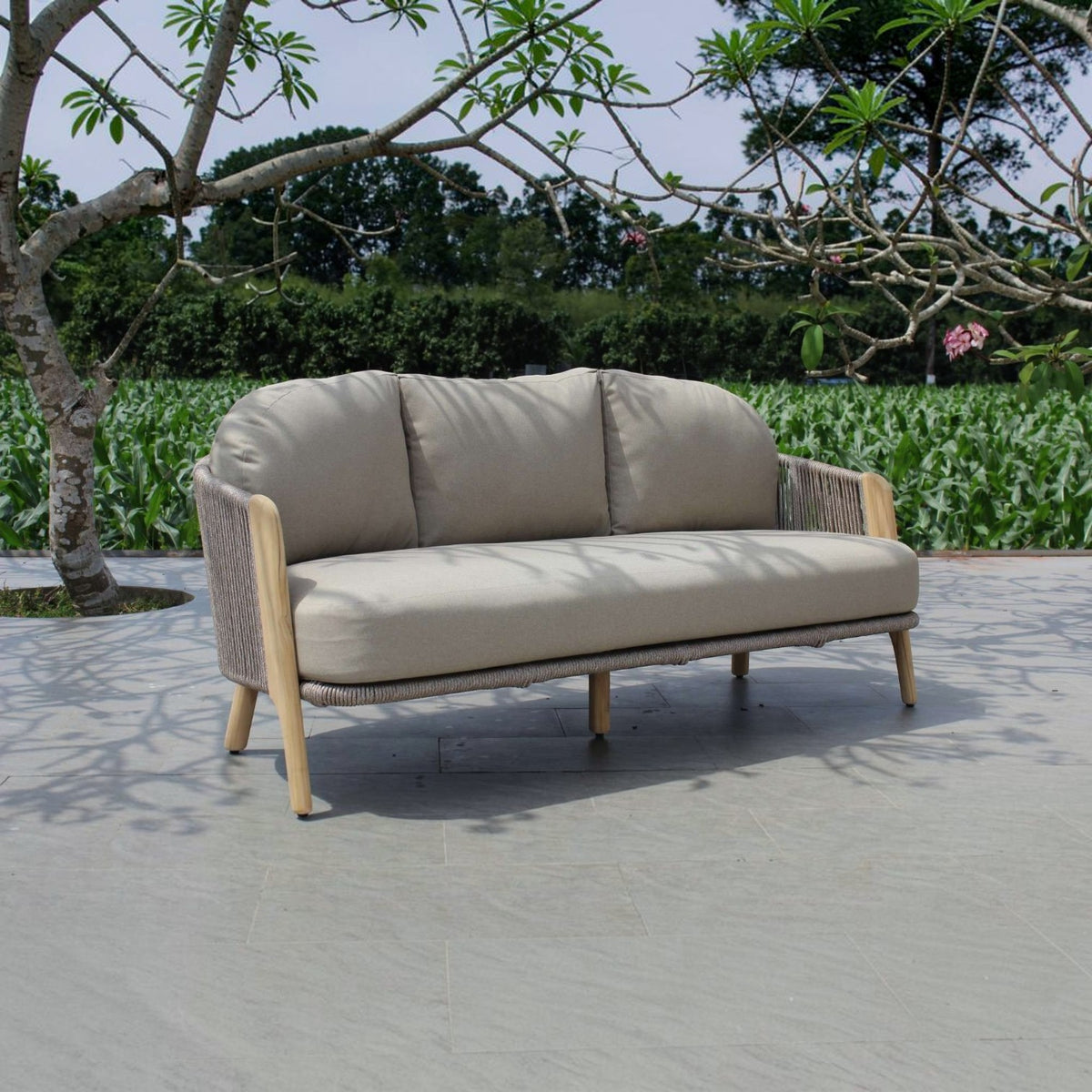 Hawaiian Discovery Furniture Cayman 3-seat outdoor sofa with beige cushions, woven rope sides, and natural wood legs.